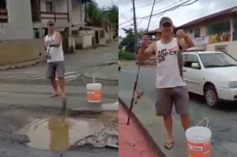 Morador 'pesca' em buraco na rua e protesta: 'tá na hora fechar a cratera!'; veja vídeo